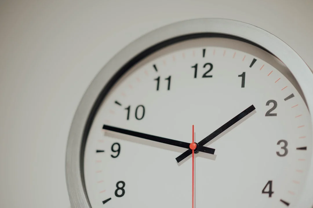 round silver analog wall clock displaying 1:48 time