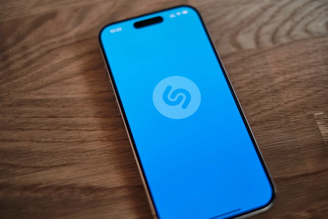 A blue phone sitting on top of a wooden table