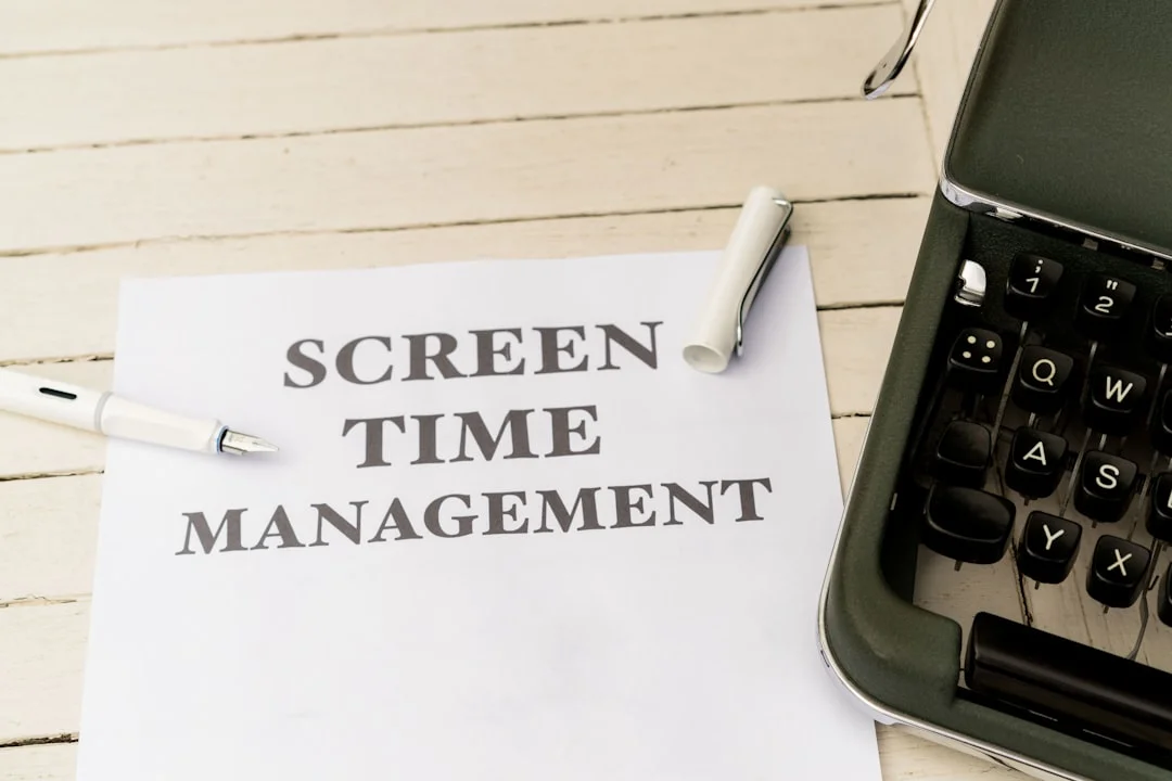a piece of paper that says screen time management next to a typewriter