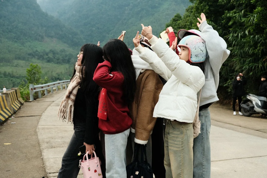 A group of people taking pictures with their cell phones