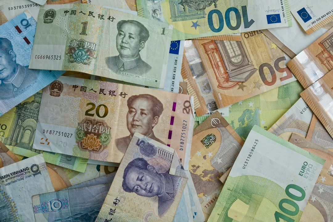 Chinese yuan and european euro banknotes scattered together.