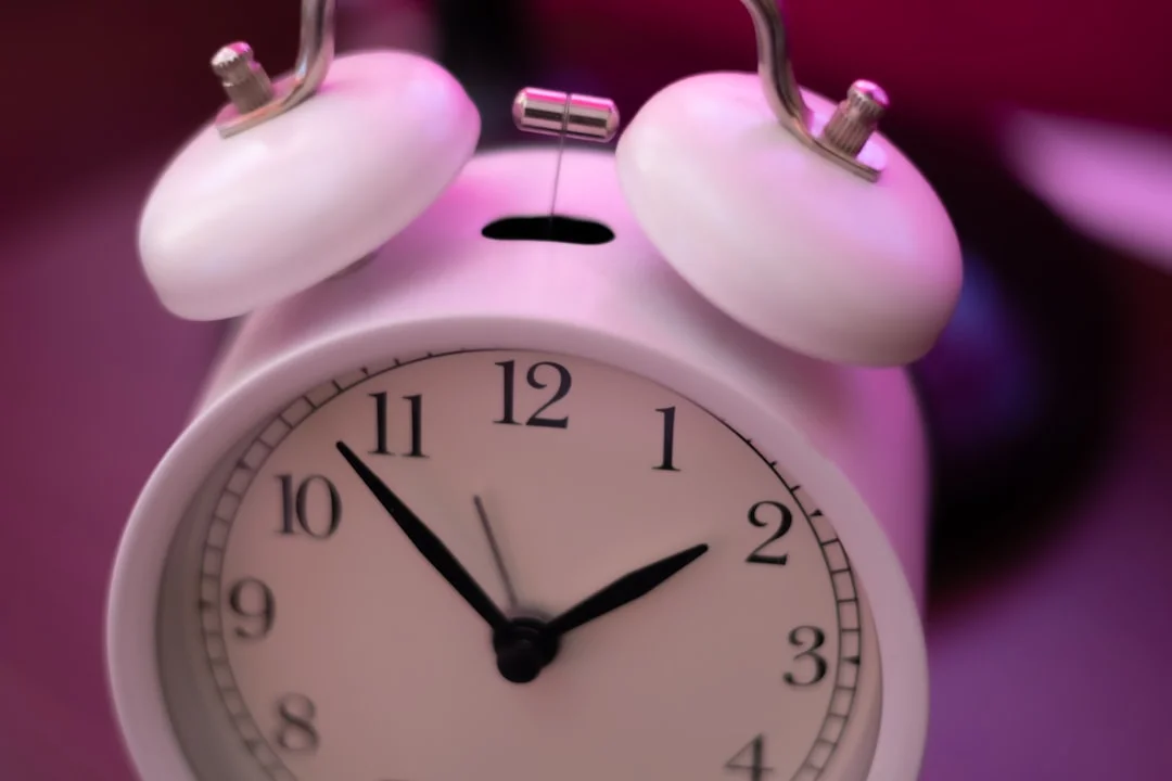 a close up of a white alarm clock