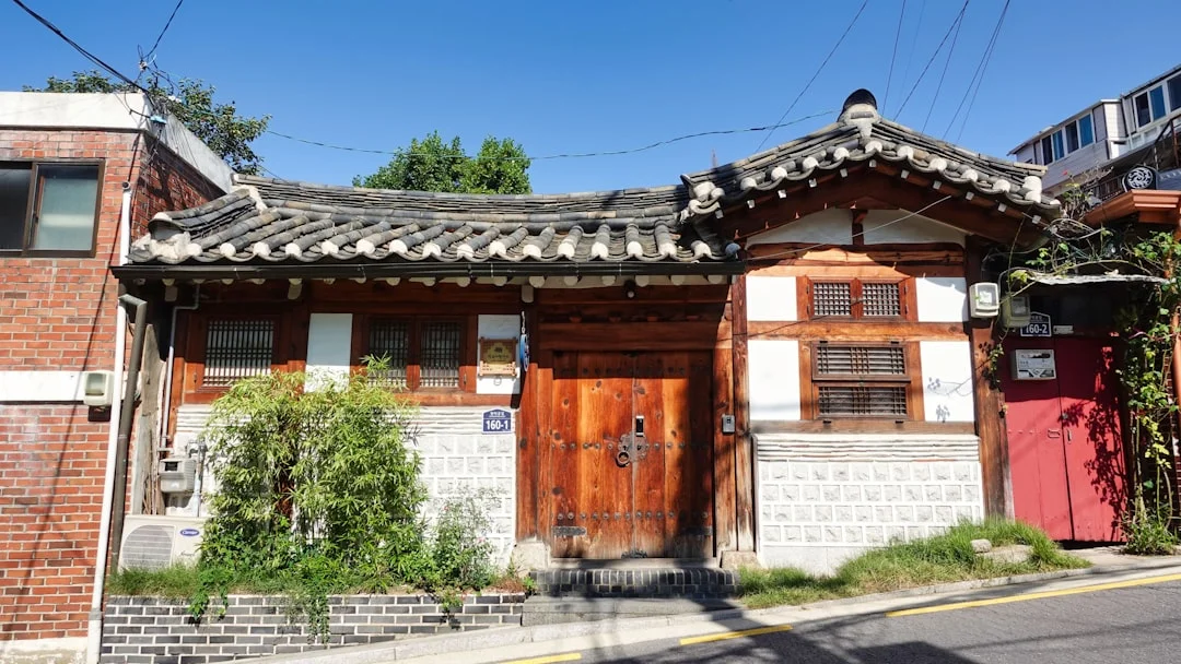 a building with a red door and a white wall