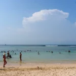People are enjoying a sunny day at the beach.