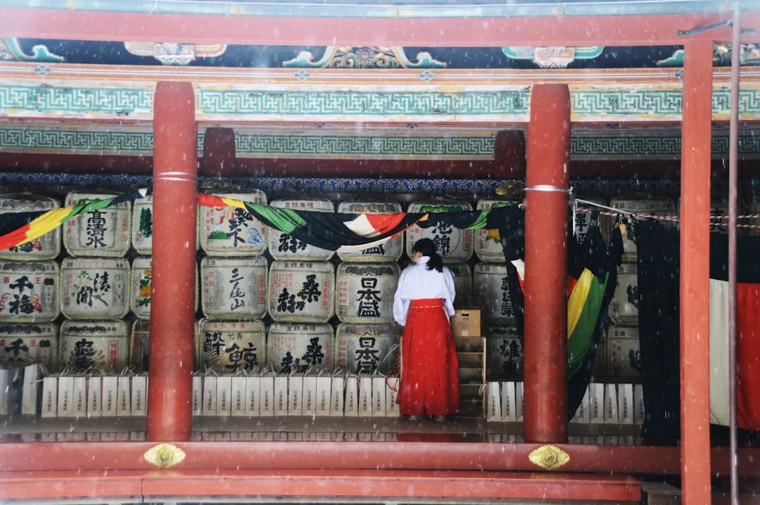 woman in white dress standing on red wooden door