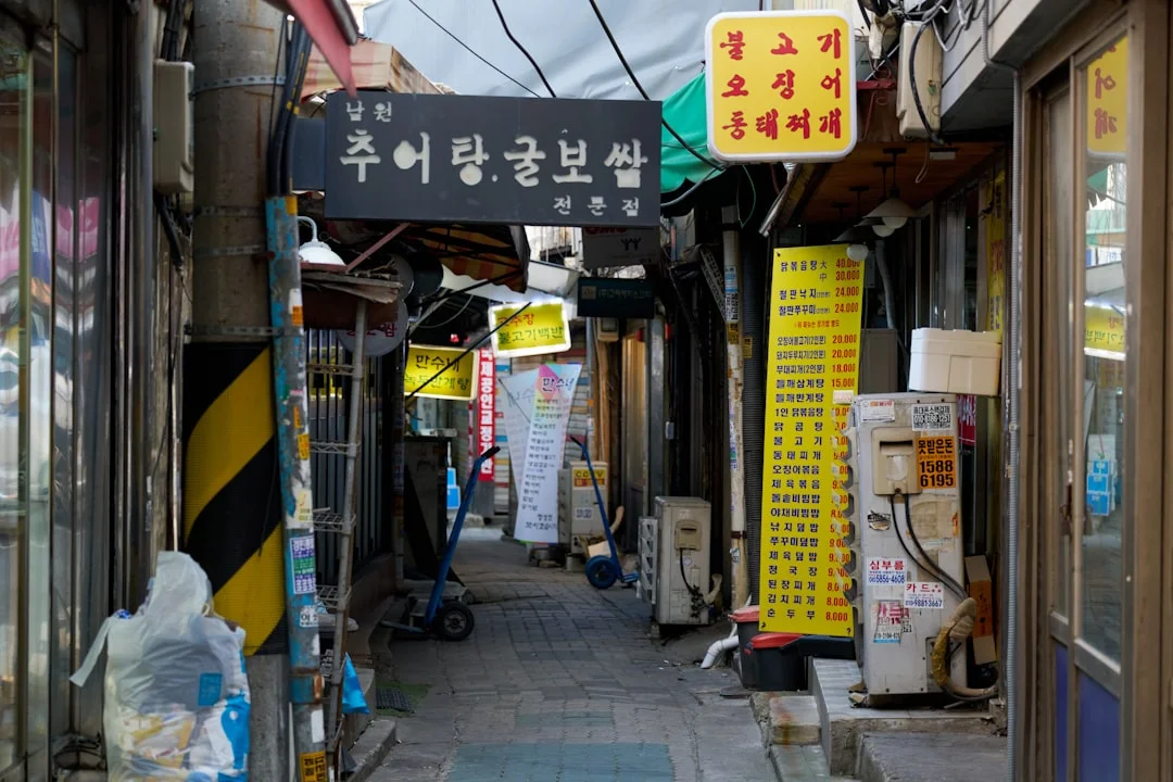 A narrow alley way with signs on the buildings