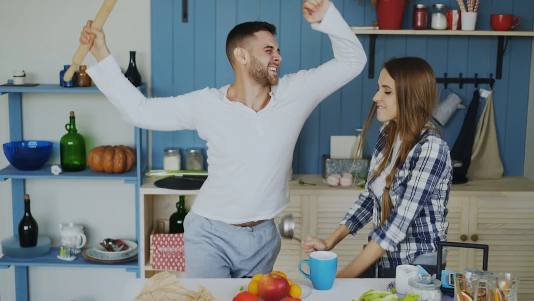 Couple dancing and having fun in the kitchen