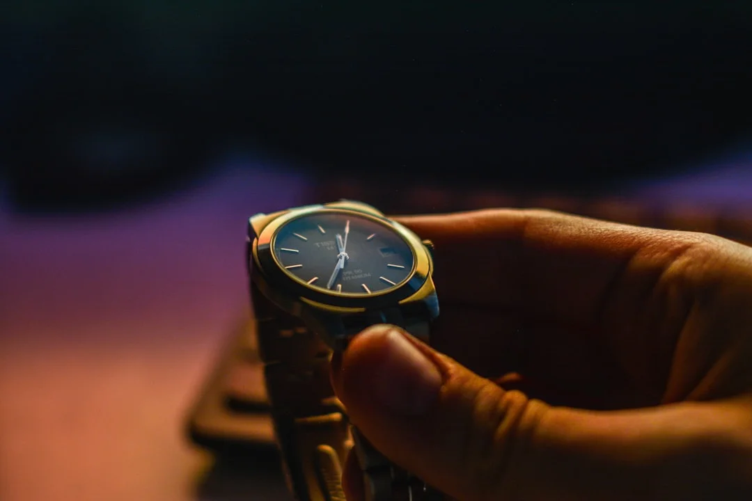 person holding silver-color analog watch
