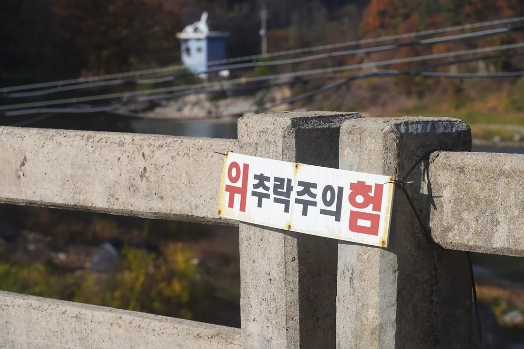A sign that is on the side of a fence
