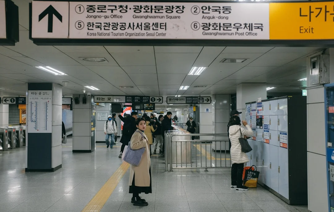 a group of people standing around a train station
