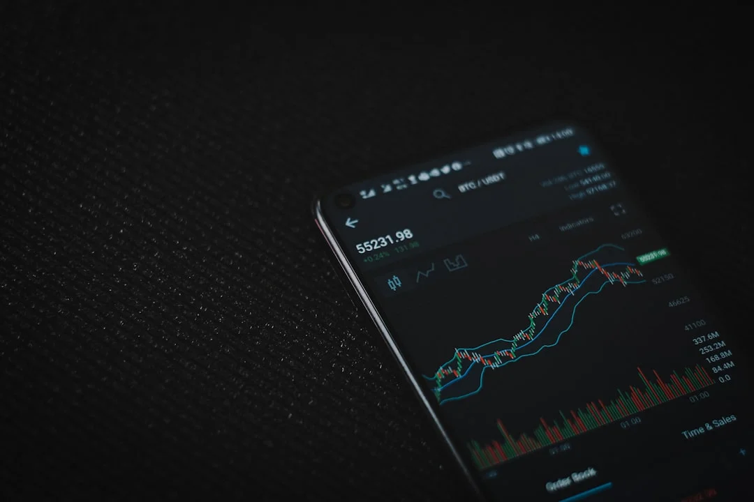 black android smartphone on black textile