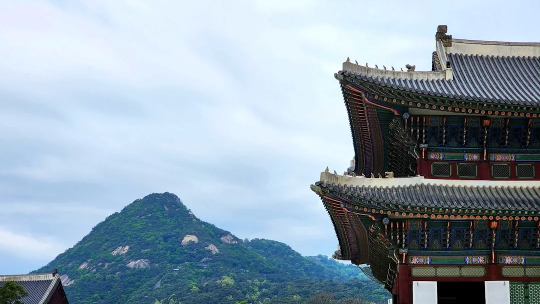 a tall building with a mountain in the background