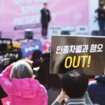 people holding up signs during day
