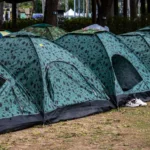 Camping tents are lined up in a row.