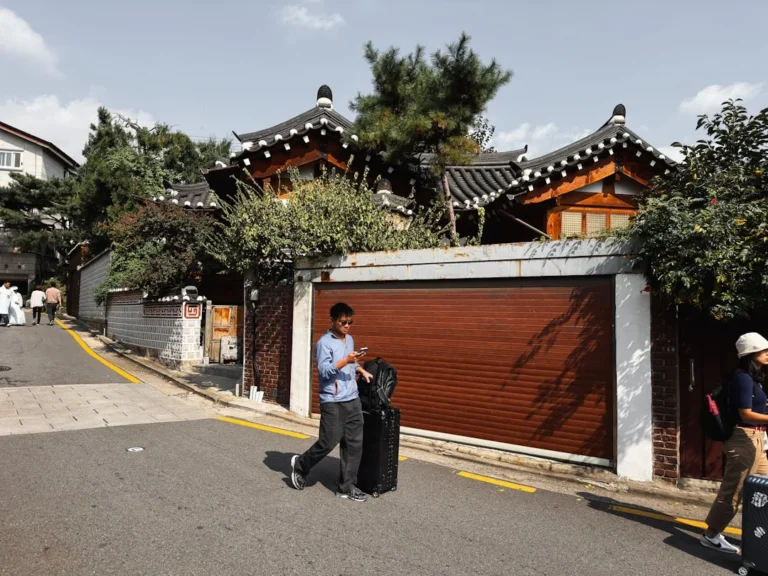 a man standing on the side of a road next to a garage