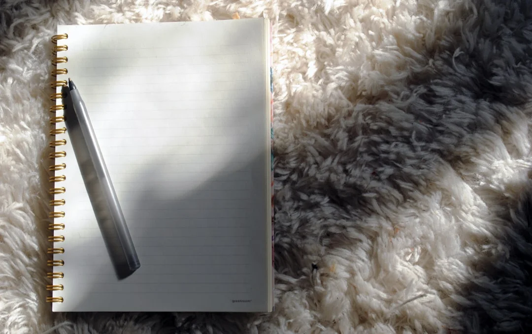 a notebook with a pen on top of it