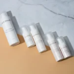 five bottles of skin care sitting on a counter