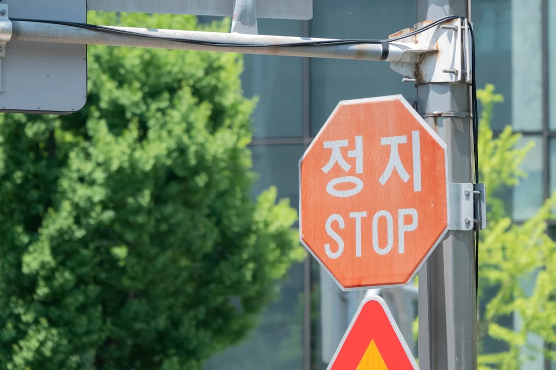 a stop sign and a yellow and red stop sign
