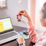 a woman sitting at a desk with a laptop computer