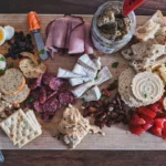 a wooden cutting board topped with different types of food