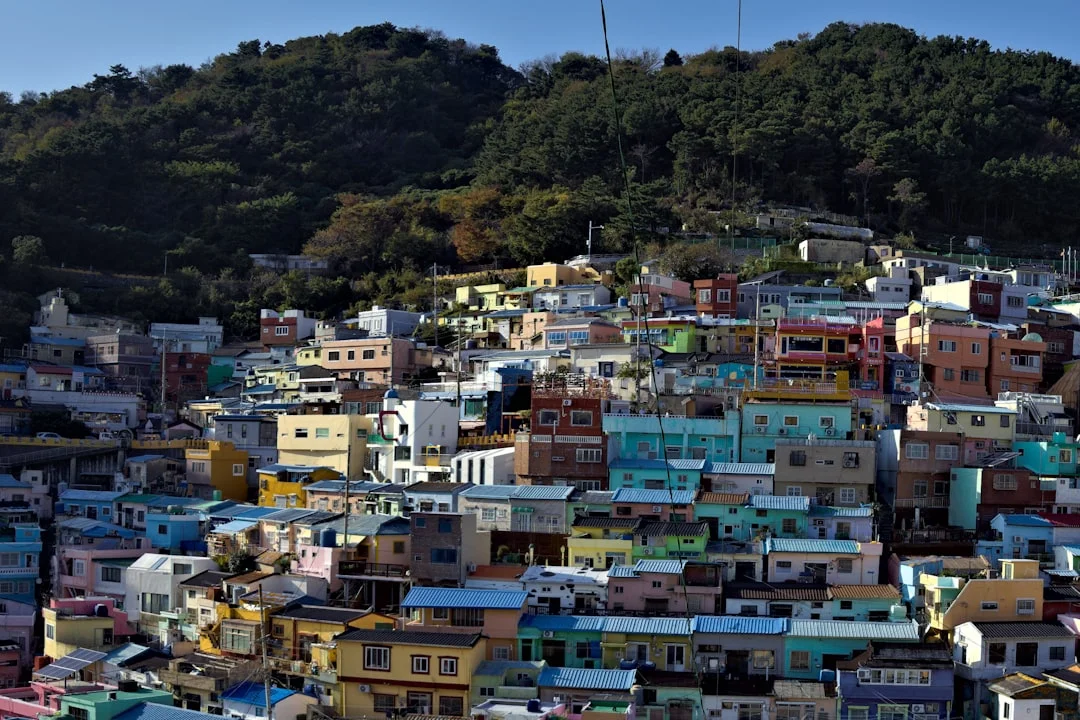 Colorful houses on a hillside under a mountain.