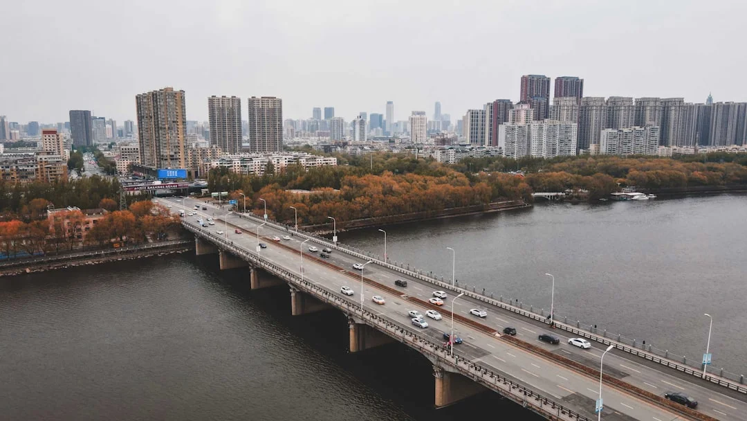 a bridge over a river with a city in the background