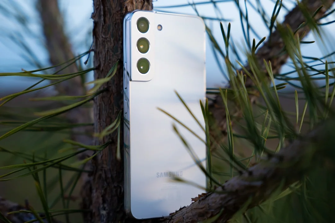 a close up of a cell phone on a tree