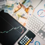 A calculator sitting on top of a pile of money