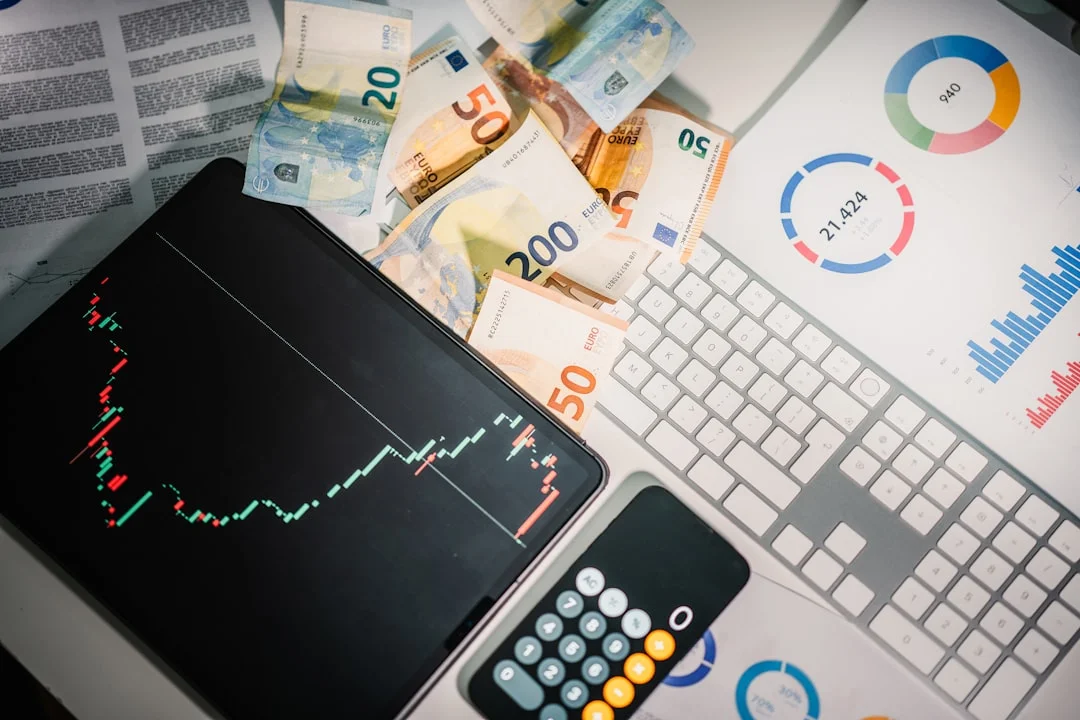 A calculator sitting on top of a pile of money