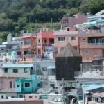 Colorful houses are nestled on a hillside.