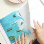 a person's hands on a book