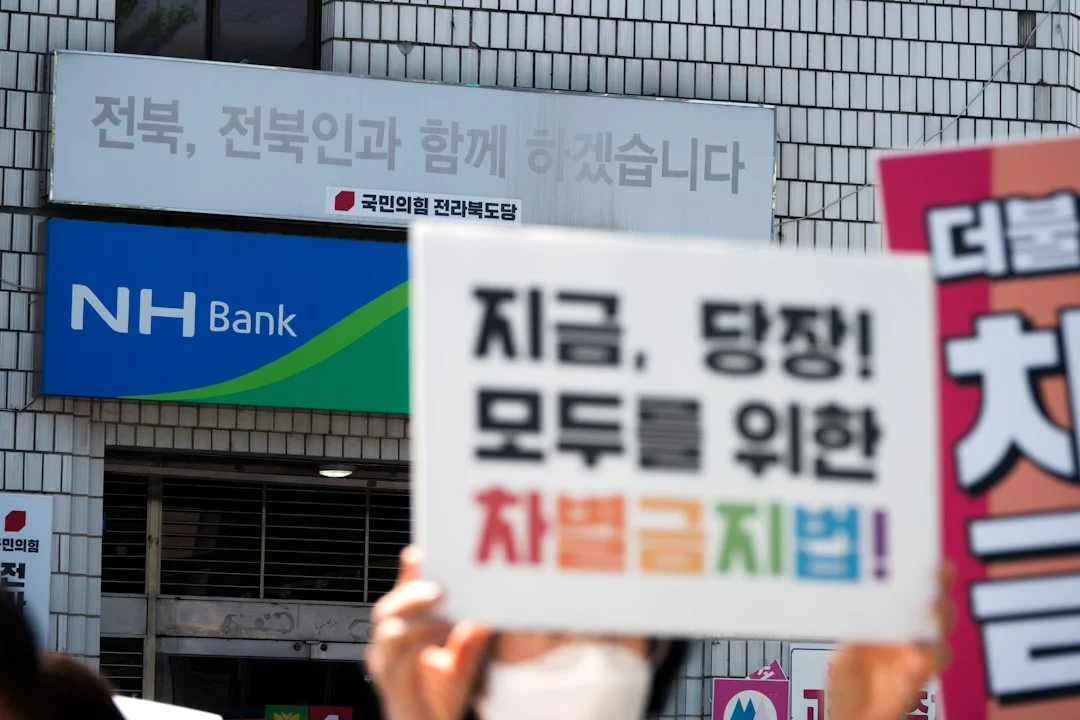 a group of people holding up signs in front of a building