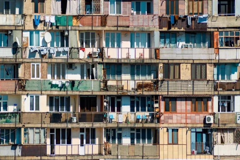 Multifamily building facade with windows and balconies.