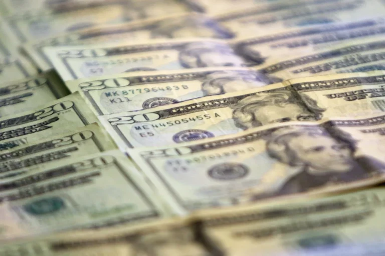 A pile of twenty dollar bills sitting on top of each other
