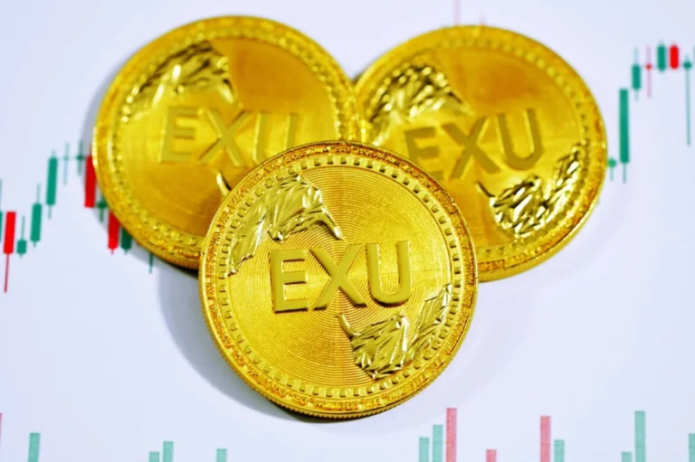 gold round coin on white surface