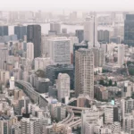 High-angle view of a dense, modern cityscape.